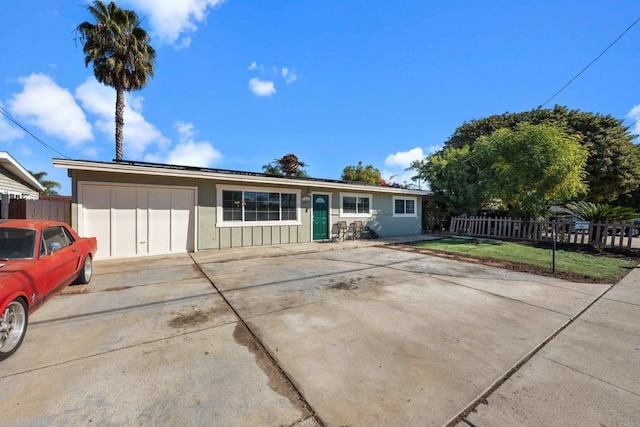 ranch-style house with a front yard and a garage