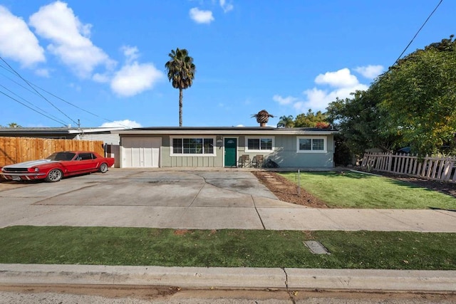 ranch-style house featuring a garage and a front yard