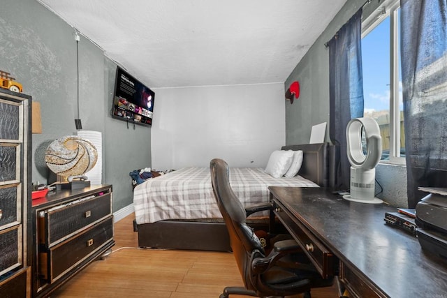 bedroom with light wood-type flooring