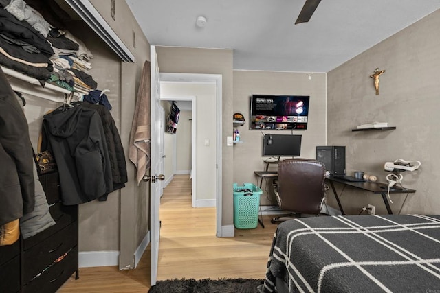 bedroom featuring ceiling fan, a closet, and hardwood / wood-style flooring