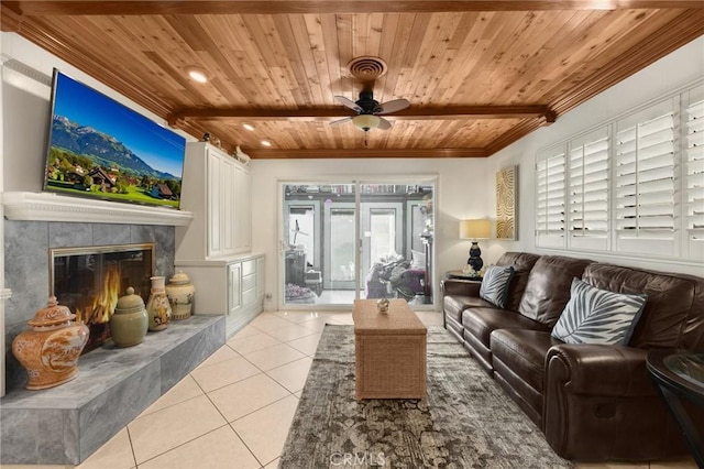 living room featuring light tile patterned floors, ceiling fan, wood ceiling, a high end fireplace, and beamed ceiling