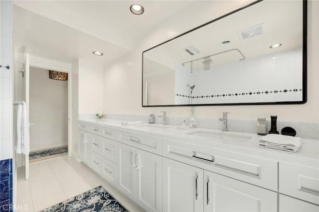 full bath with double vanity, tile patterned flooring, a sink, and recessed lighting