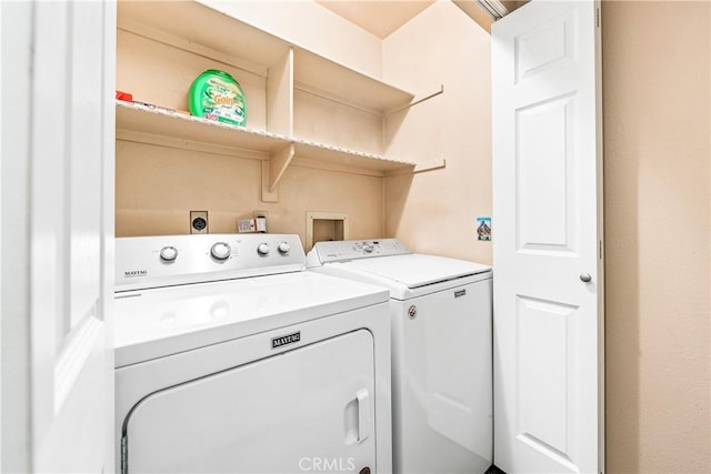 clothes washing area with washing machine and clothes dryer