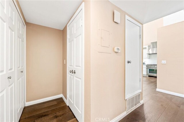 hallway with hardwood / wood-style floors