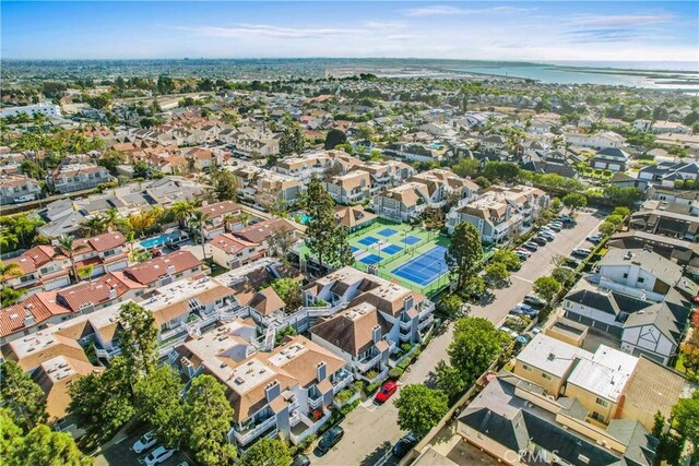 drone / aerial view featuring a residential view and a water view