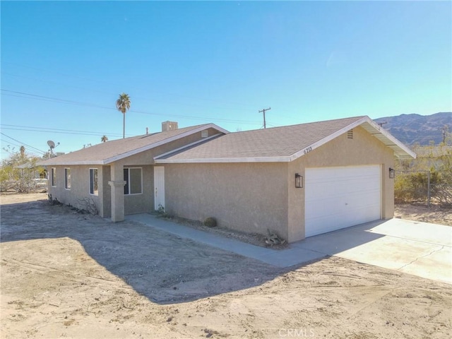 view of front of property with a garage and a mountain view