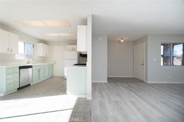 kitchen featuring green cabinetry, white refrigerator, stainless steel dishwasher, white cabinets, and sink