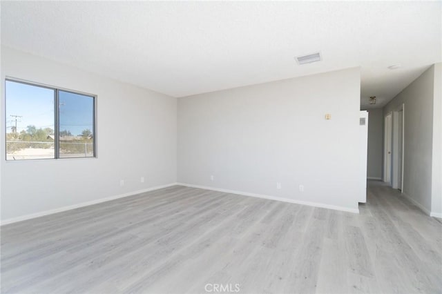 spare room featuring light wood-type flooring