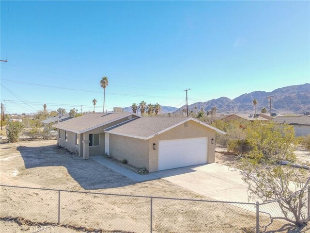 single story home featuring a mountain view and a garage