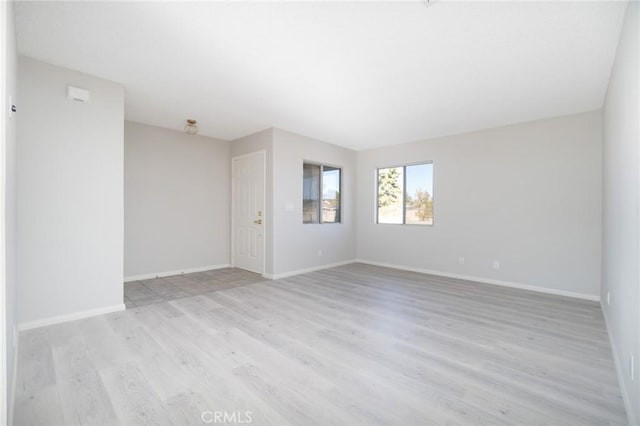 spare room with light hardwood / wood-style floors