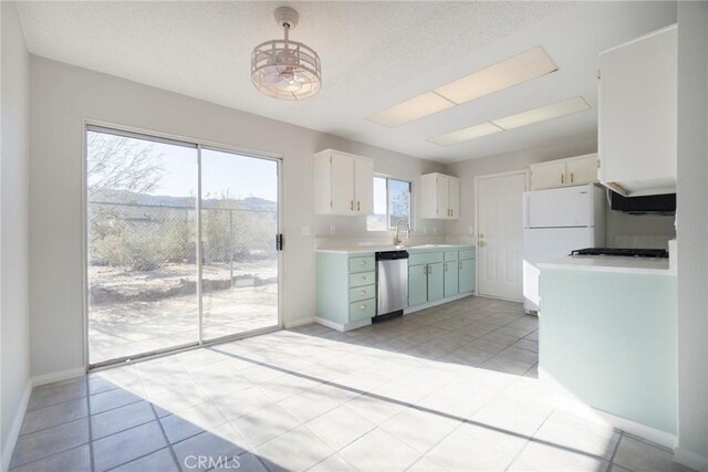 kitchen featuring a sink, white cabinetry, baseboards, light countertops, and stainless steel dishwasher