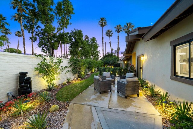 patio terrace at dusk with an outdoor living space