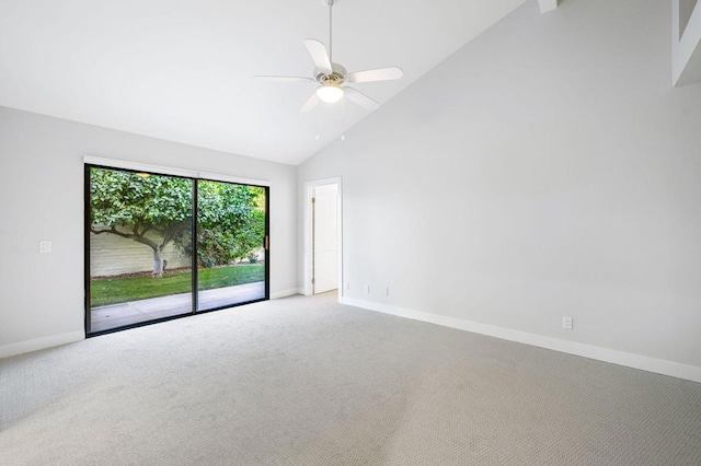 carpeted empty room with ceiling fan and high vaulted ceiling