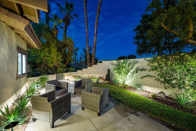 patio at twilight featuring an outdoor hangout area