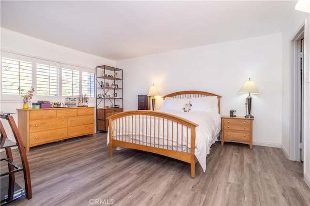 bedroom with hardwood / wood-style flooring