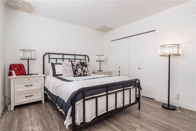 bedroom with a closet and hardwood / wood-style floors