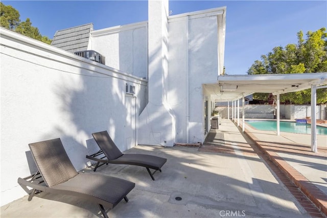 view of patio / terrace with a fenced in pool