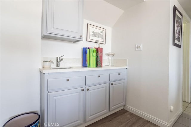 interior space featuring white cabinets, sink, and hardwood / wood-style flooring