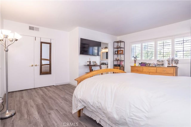 bedroom with wood-type flooring