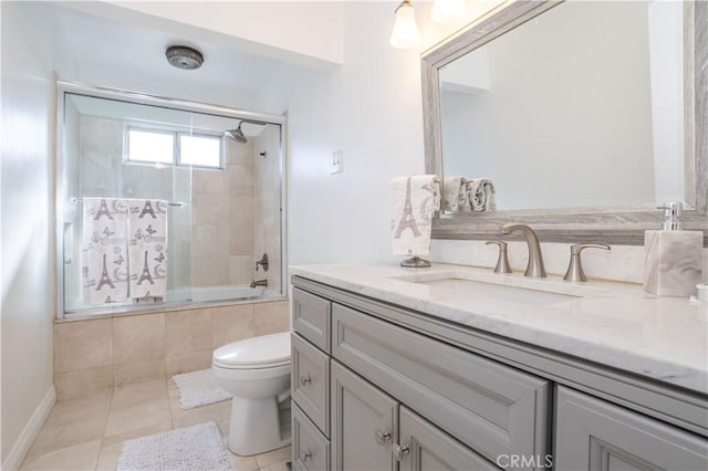 full bathroom featuring tile patterned floors, enclosed tub / shower combo, vanity, and toilet