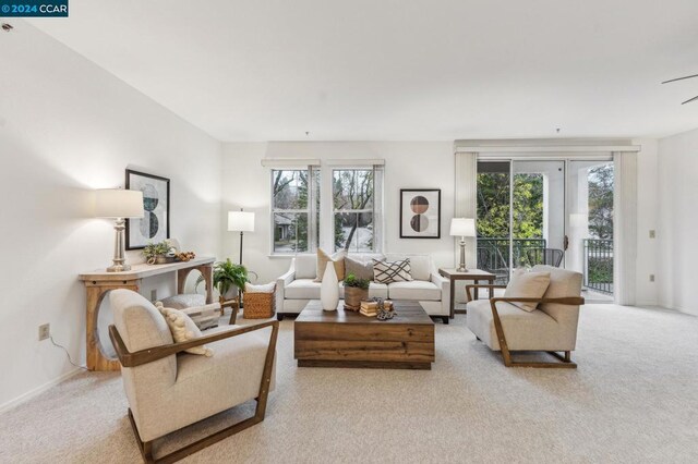 living room featuring plenty of natural light and light colored carpet