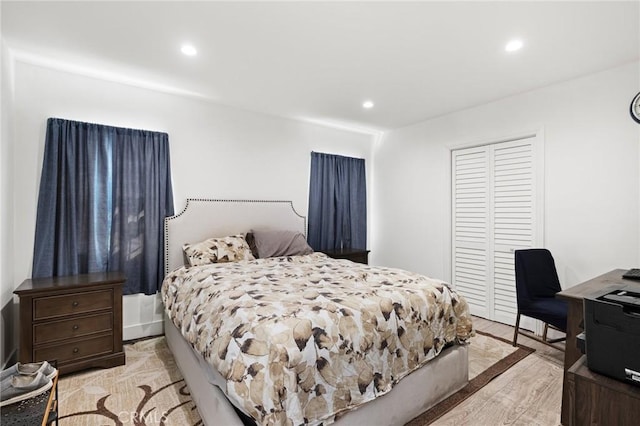 bedroom with a closet and light hardwood / wood-style floors