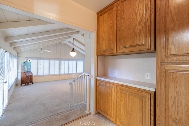 kitchen featuring ceiling fan, plenty of natural light, and vaulted ceiling with beams