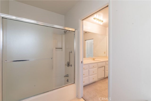 bathroom with combined bath / shower with glass door and vanity