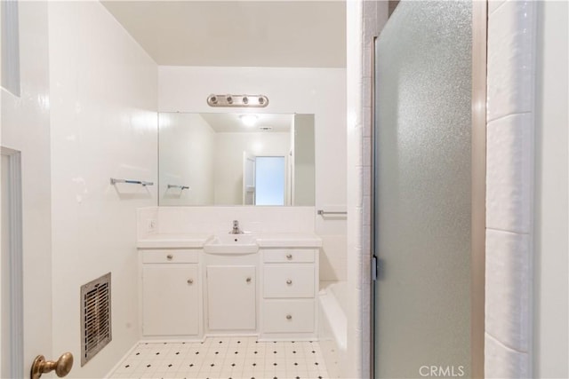 bathroom featuring walk in shower and vanity