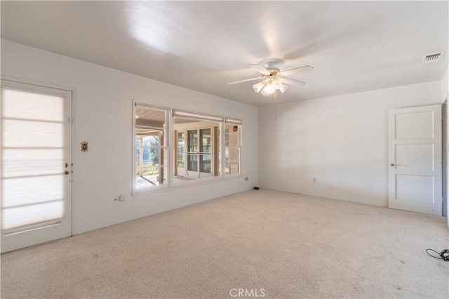 unfurnished room featuring ceiling fan and carpet floors