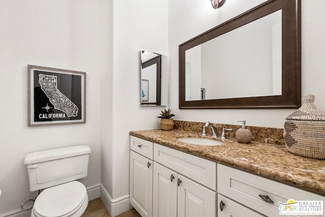 bathroom featuring toilet and vanity