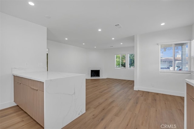 unfurnished living room featuring light hardwood / wood-style floors