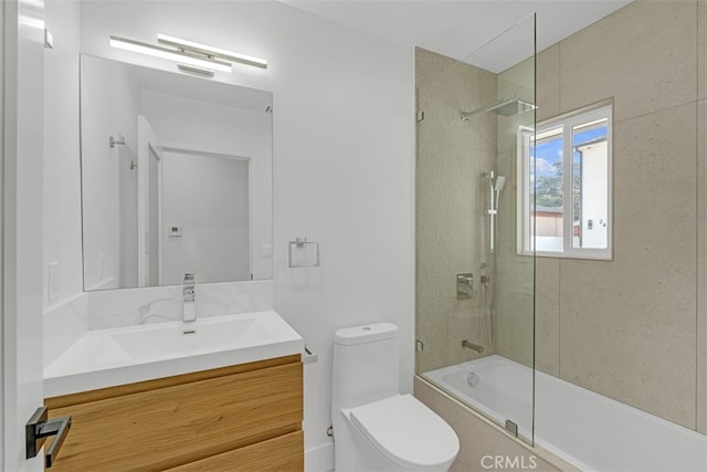 full bathroom featuring toilet, vanity, and tiled shower / bath