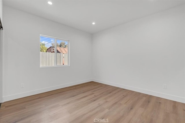 spare room featuring light hardwood / wood-style flooring