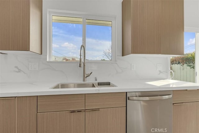 kitchen with light brown cabinetry, sink, backsplash, and dishwasher