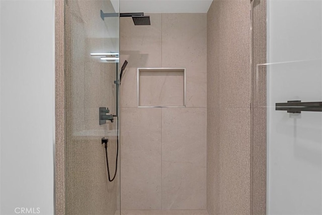 bathroom with a tile shower