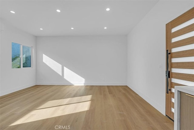 empty room with light hardwood / wood-style flooring