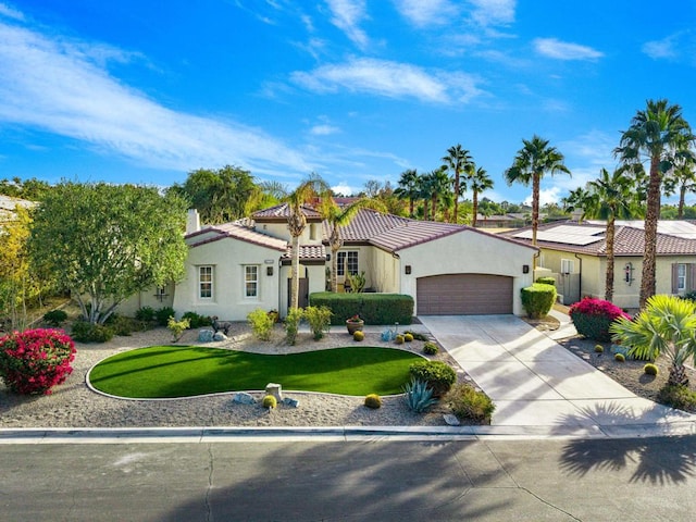 view of front of property featuring a garage and a front yard