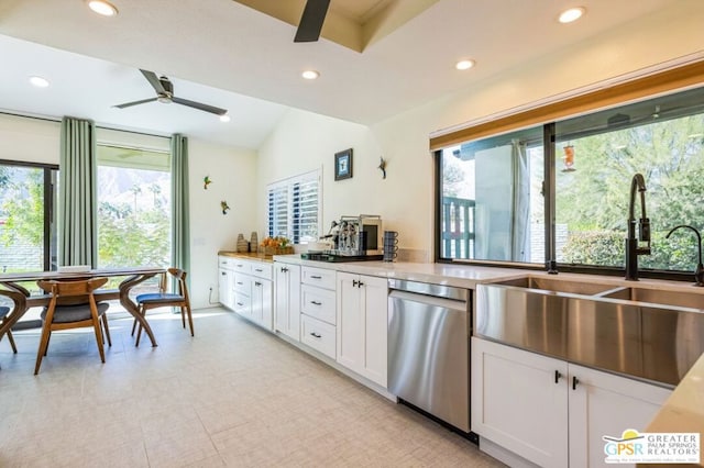 kitchen with stainless steel dishwasher, ceiling fan, plenty of natural light, and white cabinetry