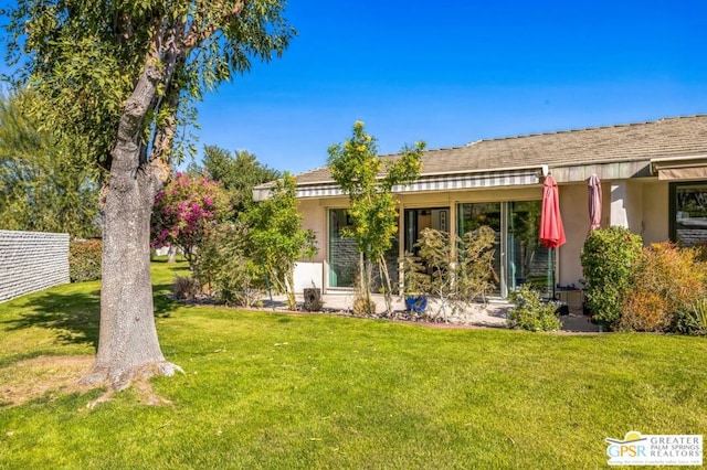 back of house featuring a yard