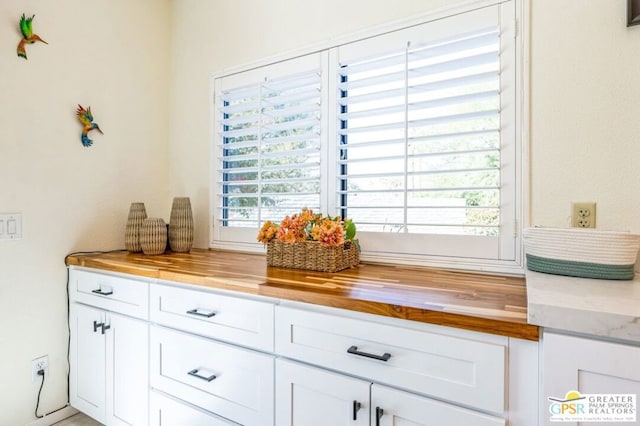 interior space featuring white cabinets and butcher block counters