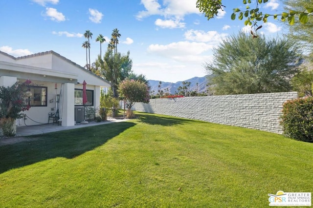 view of yard with a mountain view and a patio