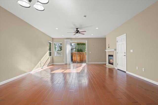 unfurnished living room featuring hardwood / wood-style floors and ceiling fan