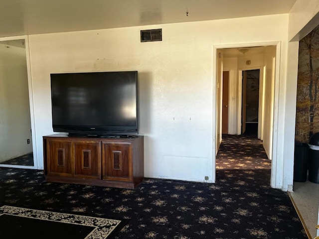 unfurnished living room with dark colored carpet