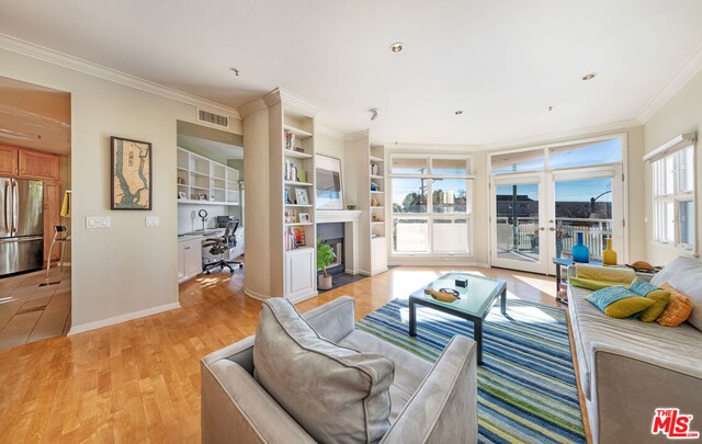 living room featuring french doors, crown molding, and light hardwood / wood-style flooring