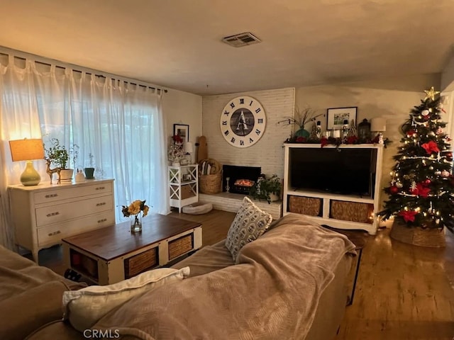 living room with hardwood / wood-style floors and a fireplace