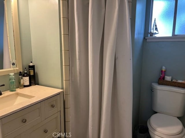 bathroom featuring toilet and vanity