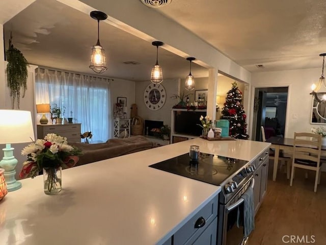 kitchen featuring decorative light fixtures, electric range, and dark hardwood / wood-style flooring