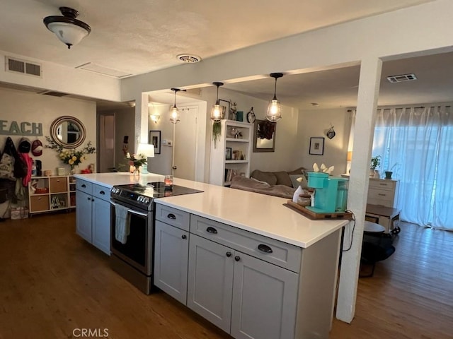 kitchen featuring electric stove, hanging light fixtures, dark hardwood / wood-style floors, and a center island