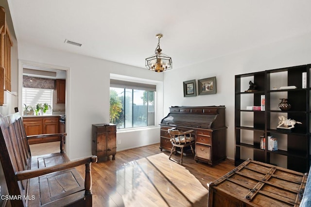 interior space with wood-type flooring and an inviting chandelier